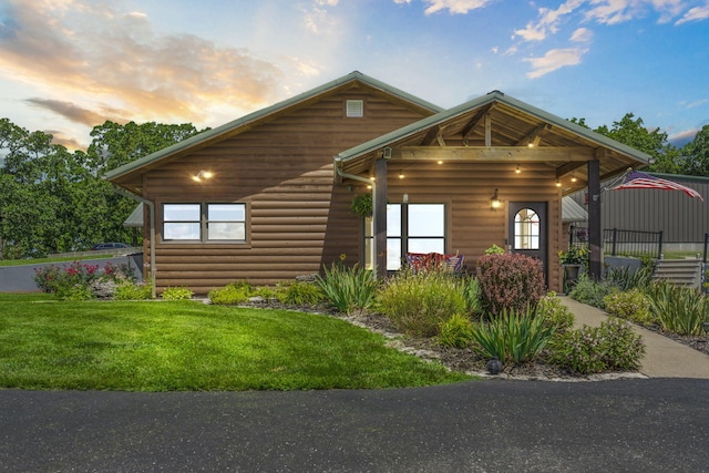 14410 Native Dr, Phillipsburg, MO 65722 - rustic home with a front lawn and log veneer siding