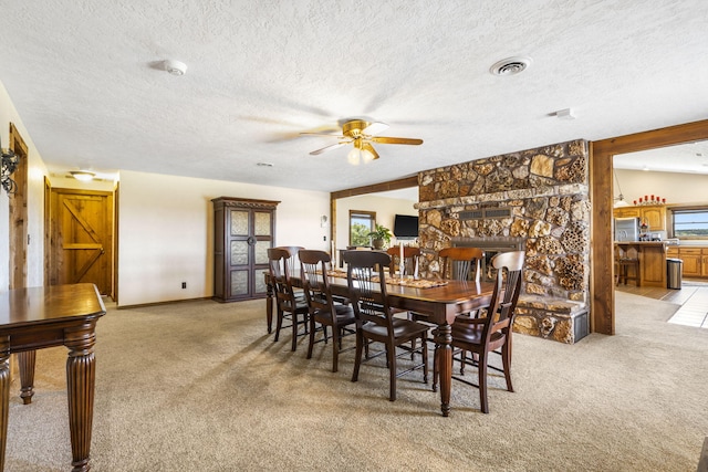14410 Native Dr, Phillipsburg, MO 65722 - dining room with light carpet, a textured ceiling, and ceiling fan
