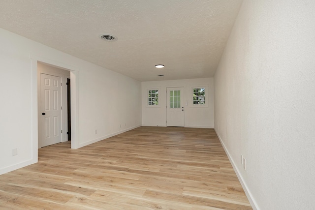 2716 W Elm St, Springfield, MO 65802 - unfurnished room featuring light wood finished floors and a textured ceiling