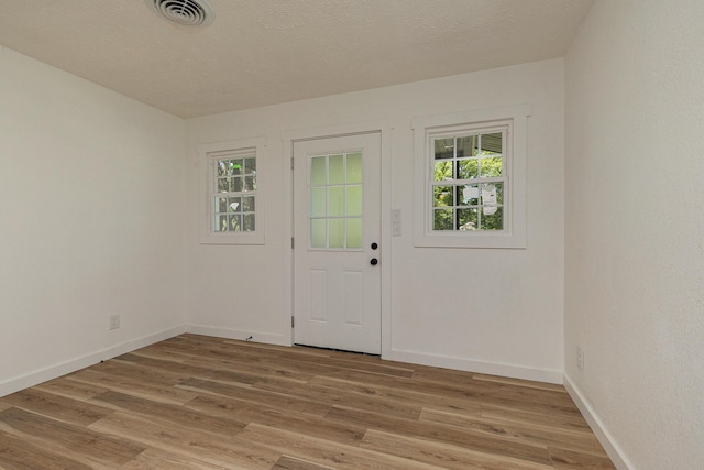 2716 W Elm St, Springfield, MO 65802 - doorway featuring light wood-style floors and baseboards