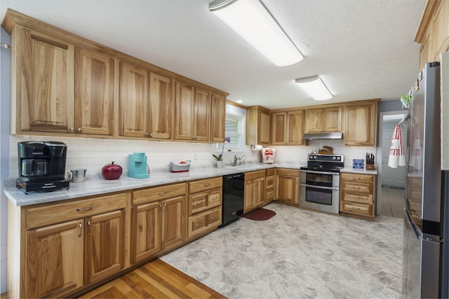 2616 Schupbach Rd, Clever, MO 65631 - kitchen featuring appliances with stainless steel finishes, under cabinet range hood, backsplash, light countertops, and a textured ceiling