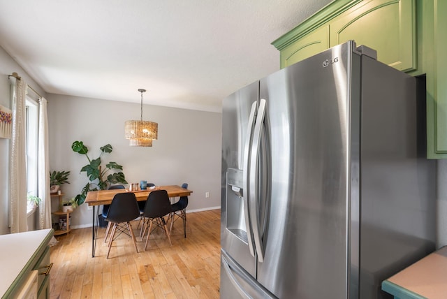 578 Stoney Path, Nixa, MO 65714 - kitchen with stainless steel refrigerator with ice dispenser, green cabinetry, light wood finished floors, and hanging light fixtures