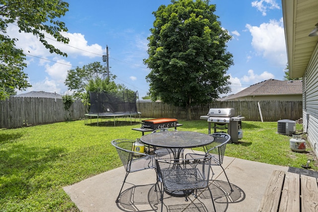 578 Stoney Path, Nixa, MO 65714 - fenced backyard with a trampoline, a grill, outdoor dining area, and a patio area