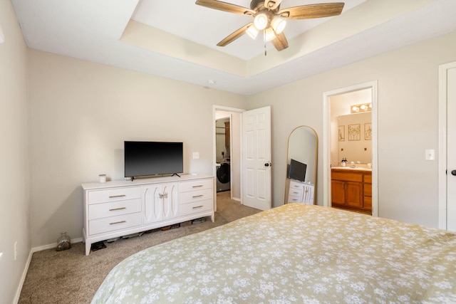 578 Stoney Path, Nixa, MO 65714 - bedroom featuring carpet, washer / dryer, a tray ceiling, ensuite bath, and a ceiling fan