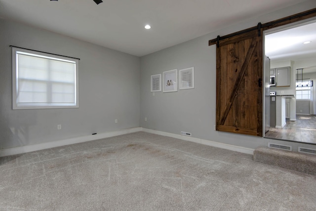 2525 New Hampshire Ave, Joplin, MO 64804 - unfurnished room with a barn door, light colored carpet, and recessed lighting