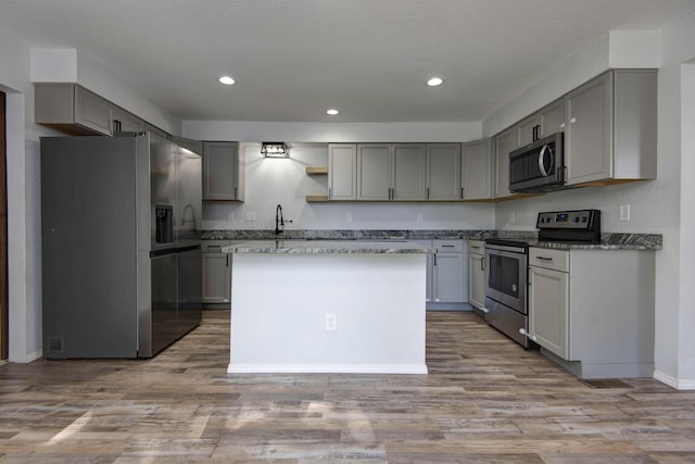 2525 New Hampshire Ave, Joplin, MO 64804 - kitchen with stainless steel appliances, open shelves, gray cabinetry, recessed lighting, and wood finished floors