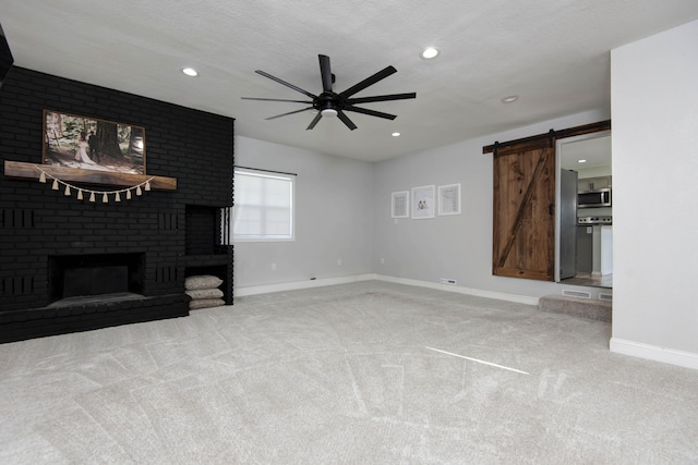 2525 New Hampshire Ave, Joplin, MO 64804 - unfurnished living room featuring a barn door, ceiling fan, carpet flooring, recessed lighting, and a fireplace