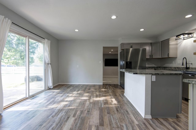 2525 New Hampshire Ave, Joplin, MO 64804 - kitchen featuring gray cabinets, appliances with stainless steel finishes, wood finished floors, recessed lighting, and dark stone countertops