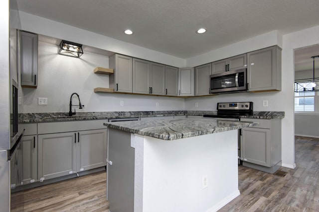 2525 New Hampshire Ave, Joplin, MO 64804 - kitchen with stainless steel appliances, gray cabinets, dark stone counters, light wood finished floors, and recessed lighting