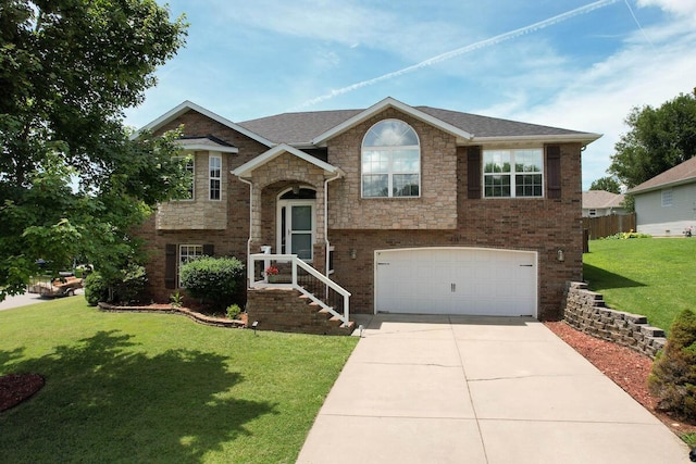 579 Lantern Hill Rd, Nixa, MO 65714 - split foyer home with a garage, driveway, a front yard, and stone siding
