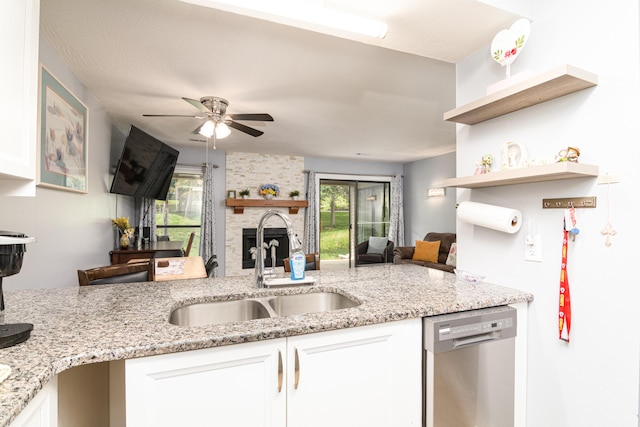 320 Turnberry Rd # 2, Branson, MO 65616 - kitchen with stainless steel dishwasher, a ceiling fan, white cabinets, open floor plan, and light stone countertops