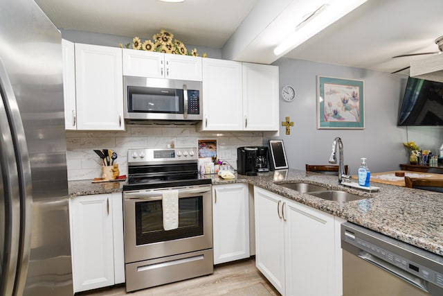 320 Turnberry Rd # 2, Branson, MO 65616 - kitchen with stainless steel appliances, white cabinets, and light stone countertops