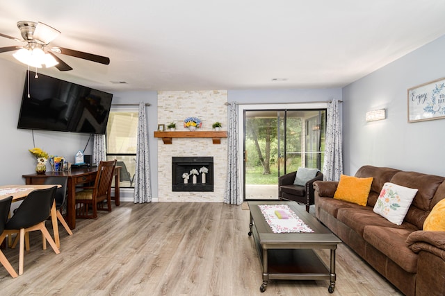320 Turnberry Rd # 2, Branson, MO 65616 - living area featuring ceiling fan, wood finished floors, and a stone fireplace