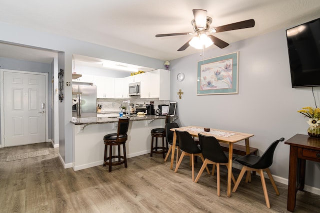 320 Turnberry Rd # 2, Branson, MO 65616 - dining area featuring wood finished floors and a ceiling fan