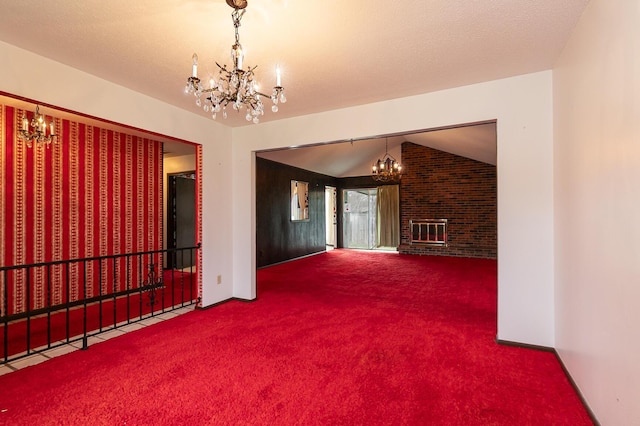 2311 E Meadow Dr, Springfield, MO 65804 - unfurnished living room featuring a chandelier, carpet, vaulted ceiling, and a brick fireplace