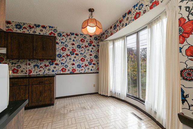 2311 E Meadow Dr, Springfield, MO 65804 - unfurnished dining area with wallpapered walls, brick patterned flooring, and wainscoting