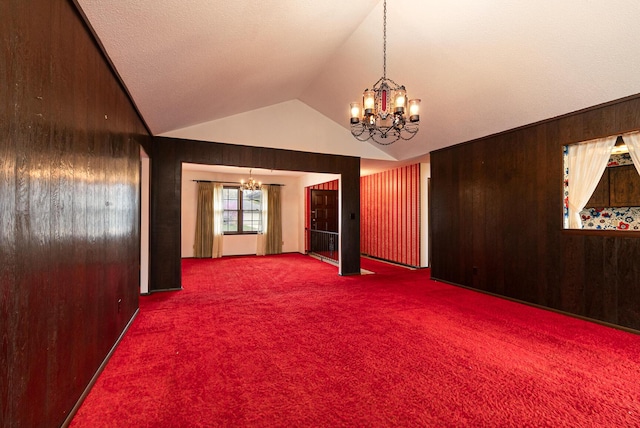 2311 E Meadow Dr, Springfield, MO 65804 - spare room featuring a chandelier, carpet floors, vaulted ceiling, and wood walls