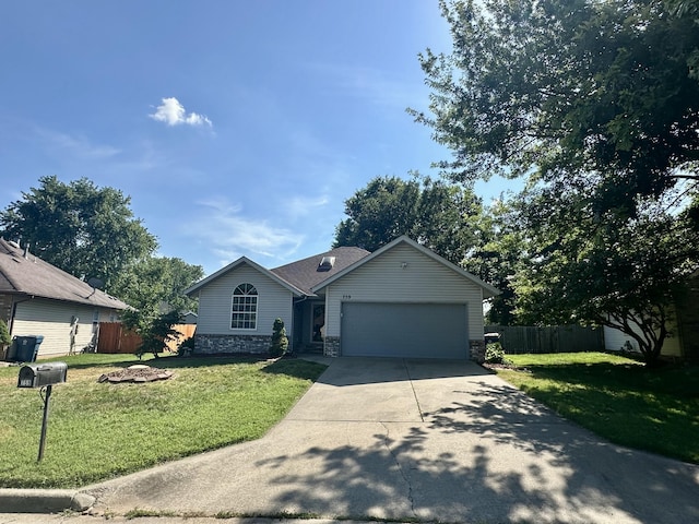 759 S Troy Ave, Springfield, MO 65802 - single story home with concrete driveway, an attached garage, and stone siding