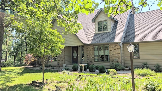 2930 S 175th Rd, El Dorado Springs, MO 64744 - view of front of house featuring brick siding, a front lawn, a chimney, and a shingled roof