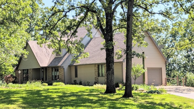 2930 S 175th Rd, El Dorado Springs, MO 64744 - view of front of house featuring driveway, a garage, a front yard, and brick siding
