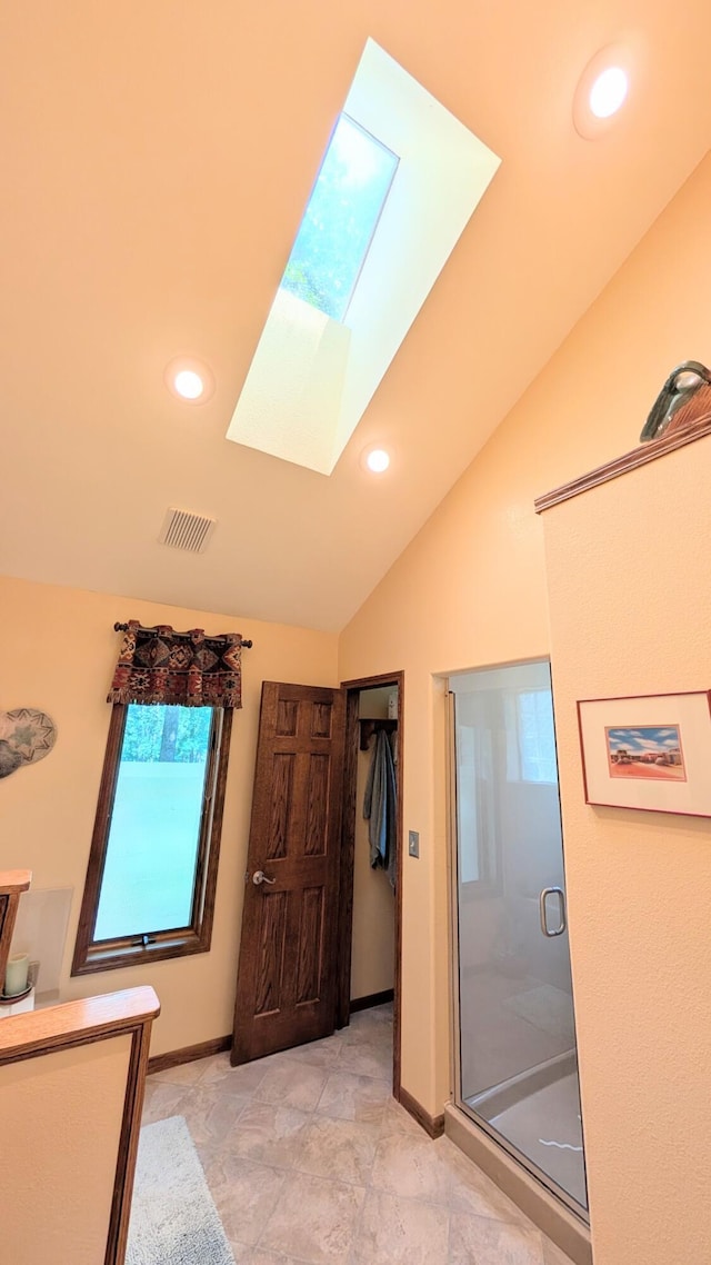 2930 S 175th Rd, El Dorado Springs, MO 64744 - bathroom featuring a skylight, a stall shower, vaulted ceiling, and recessed lighting