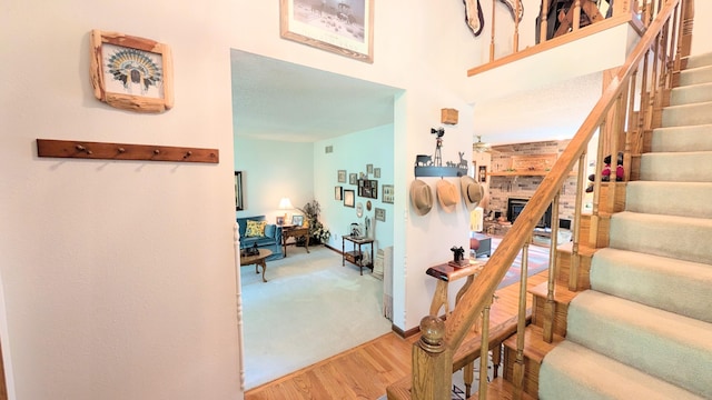 2930 S 175th Rd, El Dorado Springs, MO 64744 - stairs with wood finished floors and a towering ceiling