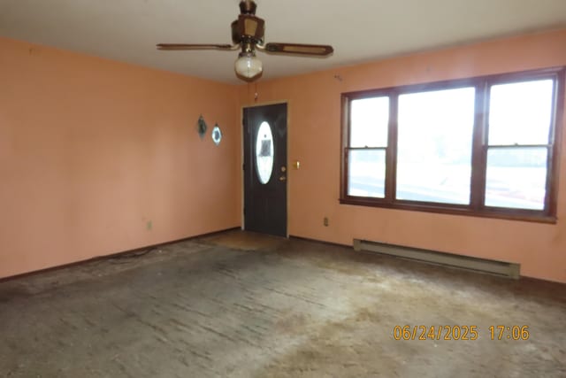 321 W Cofield St, Aurora, MO 65605 - carpeted entrance foyer featuring a baseboard radiator and ceiling fan