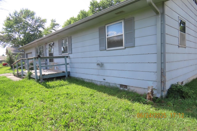321 W Cofield St, Aurora, MO 65605 - view of home's exterior featuring crawl space, a wooden deck, and a lawn
