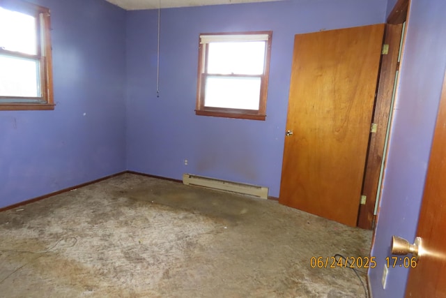 321 W Cofield St, Aurora, MO 65605 - unfurnished room with a baseboard heating unit, carpet floors, and healthy amount of natural light