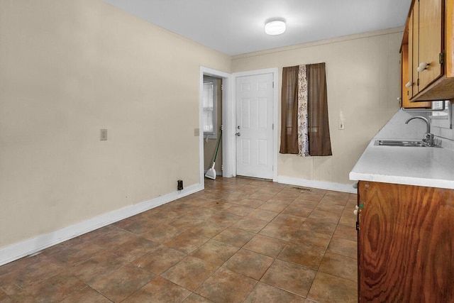 220 W Portland St, Springfield, MO 65807 - unfurnished dining area with a sink and baseboards