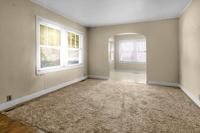 220 W Portland St, Springfield, MO 65807 - carpeted empty room featuring arched walkways and baseboards