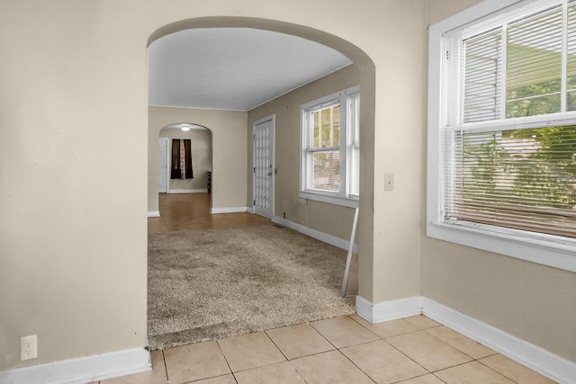 220 W Portland St, Springfield, MO 65807 - foyer featuring arched walkways, light tile patterned floors, and light colored carpet