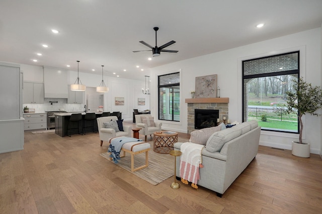 3945 E Woodhue St, Springfield, MO 65802 - living room featuring light wood-type flooring, ceiling fan, recessed lighting, and a stone fireplace