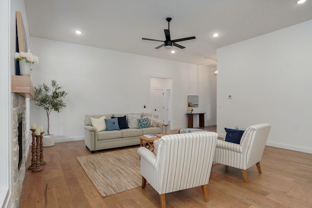 3945 E Woodhue St, Springfield, MO 65802 - living room featuring a ceiling fan, wood finished floors, a stone fireplace, and recessed lighting