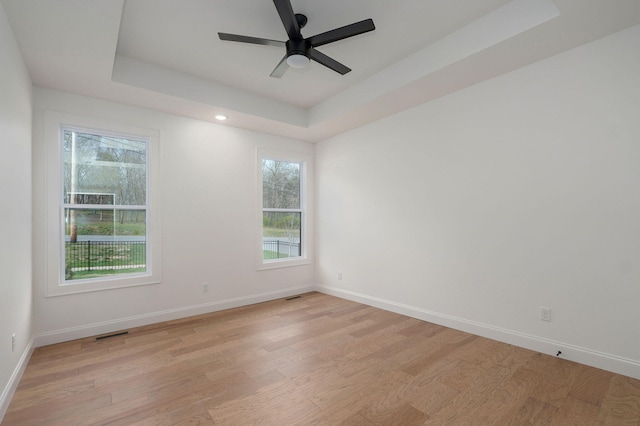 3945 E Woodhue St, Springfield, MO 65802 - unfurnished room featuring a tray ceiling, light wood-style flooring, a ceiling fan, and recessed lighting