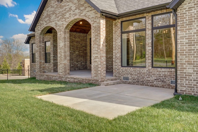 3945 E Woodhue St, Springfield, MO 65802 - view of exterior entry featuring a patio, brick siding, and roof with shingles