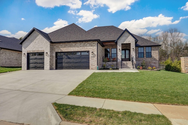 3945 E Woodhue St, Springfield, MO 65802 - french country style house with an attached garage, brick siding, a front yard, driveway, and roof with shingles