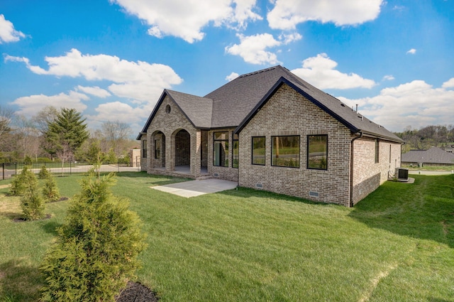 3945 E Woodhue St, Springfield, MO 65802 - rear view of property featuring brick siding, a patio, and roof with shingles