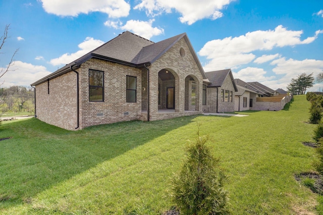 3945 E Woodhue St, Springfield, MO 65802 - back of property featuring brick siding, a lawn, and a shingled roof