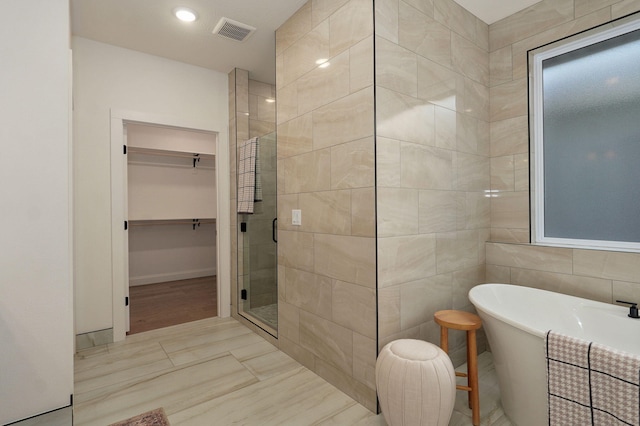 3945 E Woodhue St, Springfield, MO 65802 - full bath with a shower stall, a walk in closet, and a freestanding bath