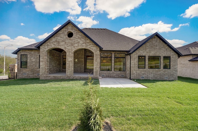 3945 E Woodhue St, Springfield, MO 65802 - back of property featuring brick siding, a patio area, crawl space, and a shingled roof