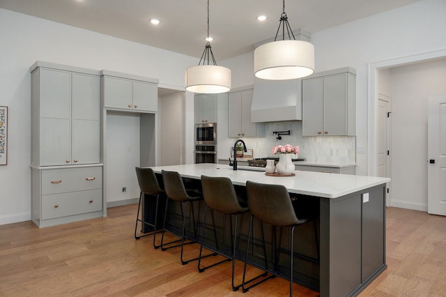 3945 E Woodhue St, Springfield, MO 65802 - kitchen featuring appliances with stainless steel finishes, decorative backsplash, custom exhaust hood, gray cabinetry, and recessed lighting