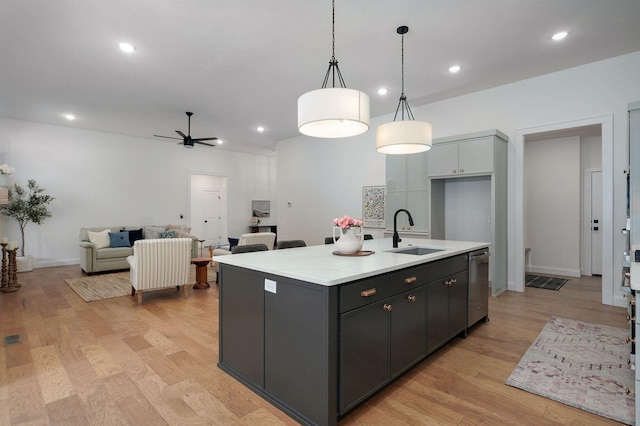 3945 E Woodhue St, Springfield, MO 65802 - kitchen with a ceiling fan, light countertops, an island with sink, light wood finished floors, and recessed lighting