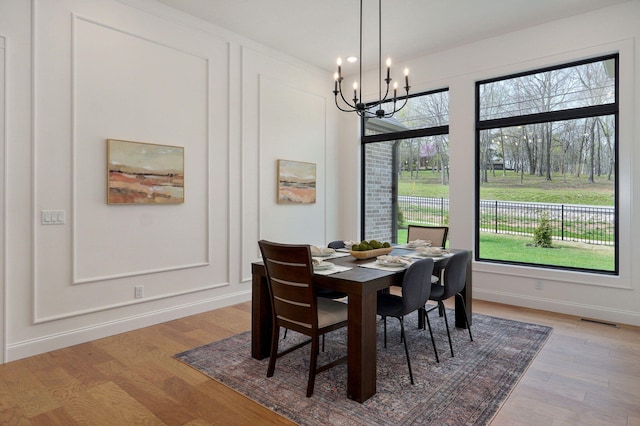 3945 E Woodhue St, Springfield, MO 65802 - dining space with a chandelier and light wood-style floors