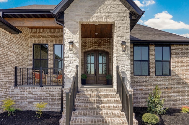3945 E Woodhue St, Springfield, MO 65802 - doorway to property with french doors, brick siding, a shingled roof, and stone siding