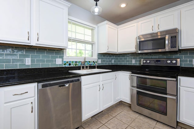 805 S Benson Pl, Nixa, MO 65714 - kitchen featuring stainless steel appliances, white cabinets, decorative backsplash, light tile patterned flooring, and hanging light fixtures