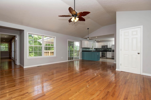 805 S Benson Pl, Nixa, MO 65714 - unfurnished living room with light wood-style floors, lofted ceiling, ceiling fan, and healthy amount of natural light