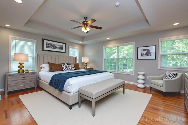 805 S Benson Pl, Nixa, MO 65714 - bedroom featuring a tray ceiling, wood finished floors, recessed lighting, and ceiling fan