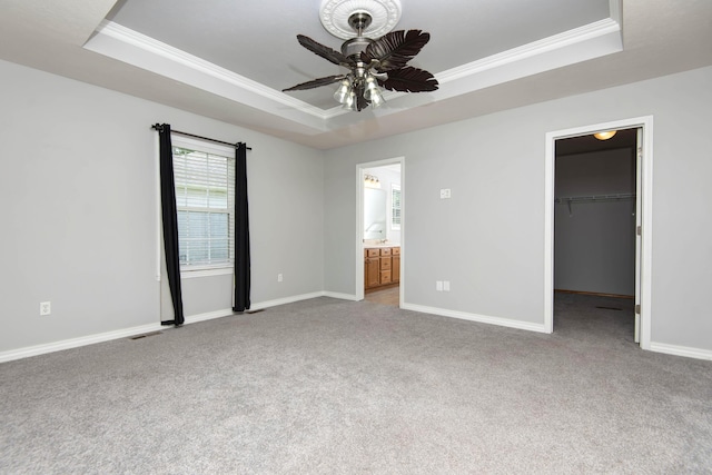 805 S Benson Pl, Nixa, MO 65714 - unfurnished bedroom with a raised ceiling, ornamental molding, carpet floors, a spacious closet, and ceiling fan