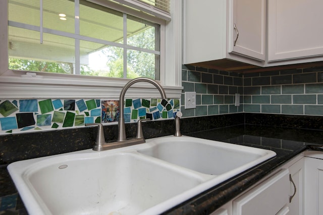 805 S Benson Pl, Nixa, MO 65714 - kitchen view of white cabinetry, backsplash, and dark countertops